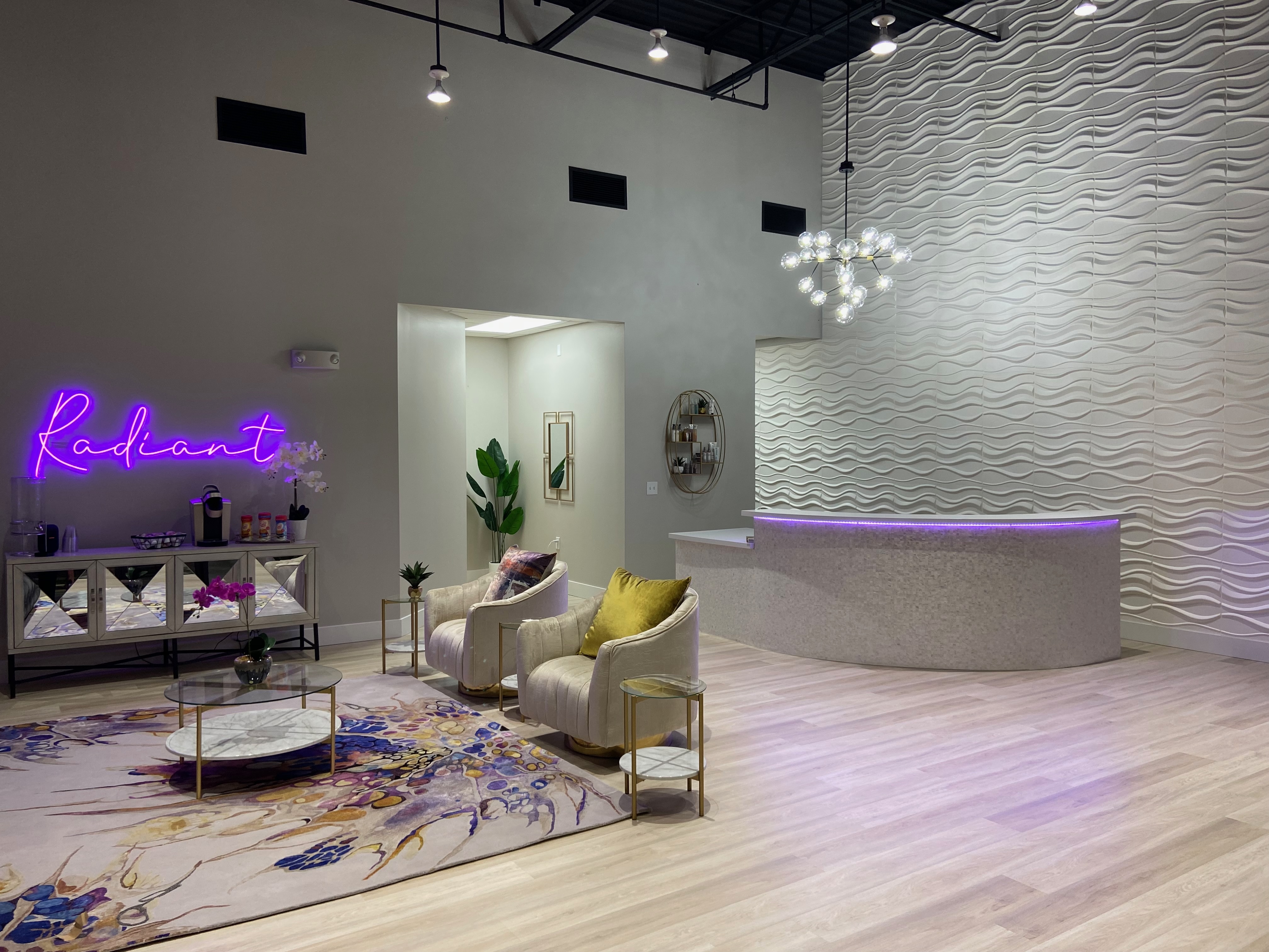 Inside Radiant Med Spa featuring a luxury lobby with a wave wall and neon sign